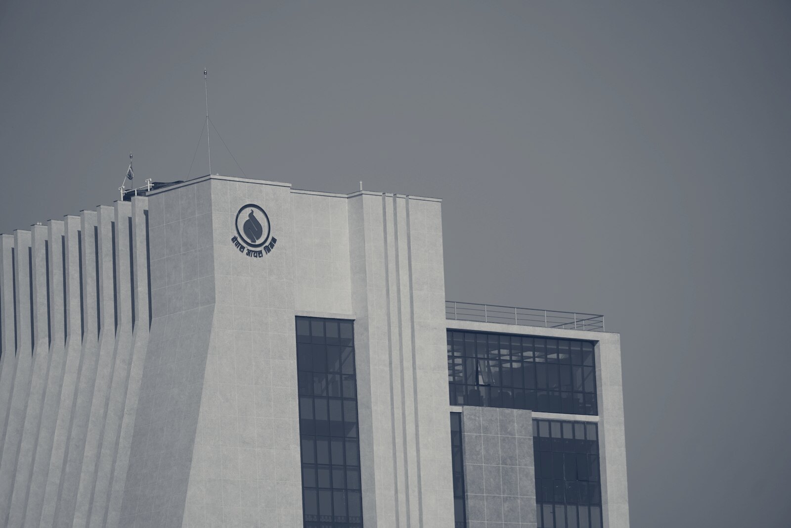 Modern building with a logo against clear sky