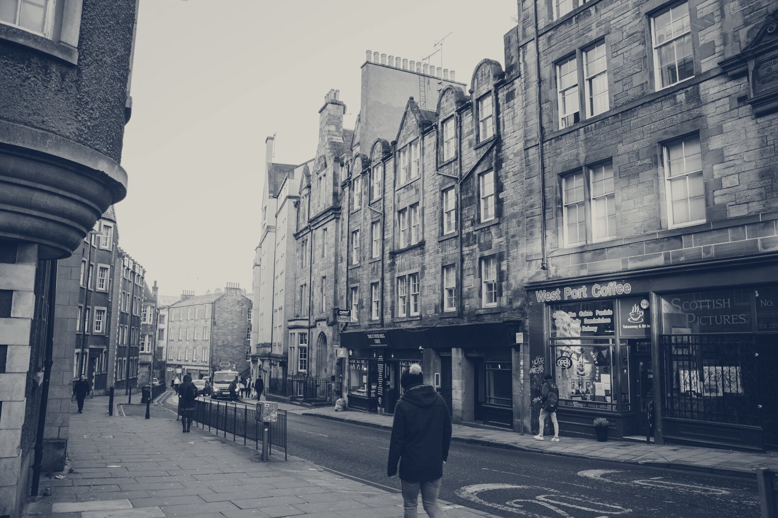 A street scene with old buildings and people walking